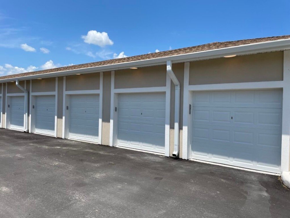 Row of newly installed residential sectional garage doors at a multi-unit development
